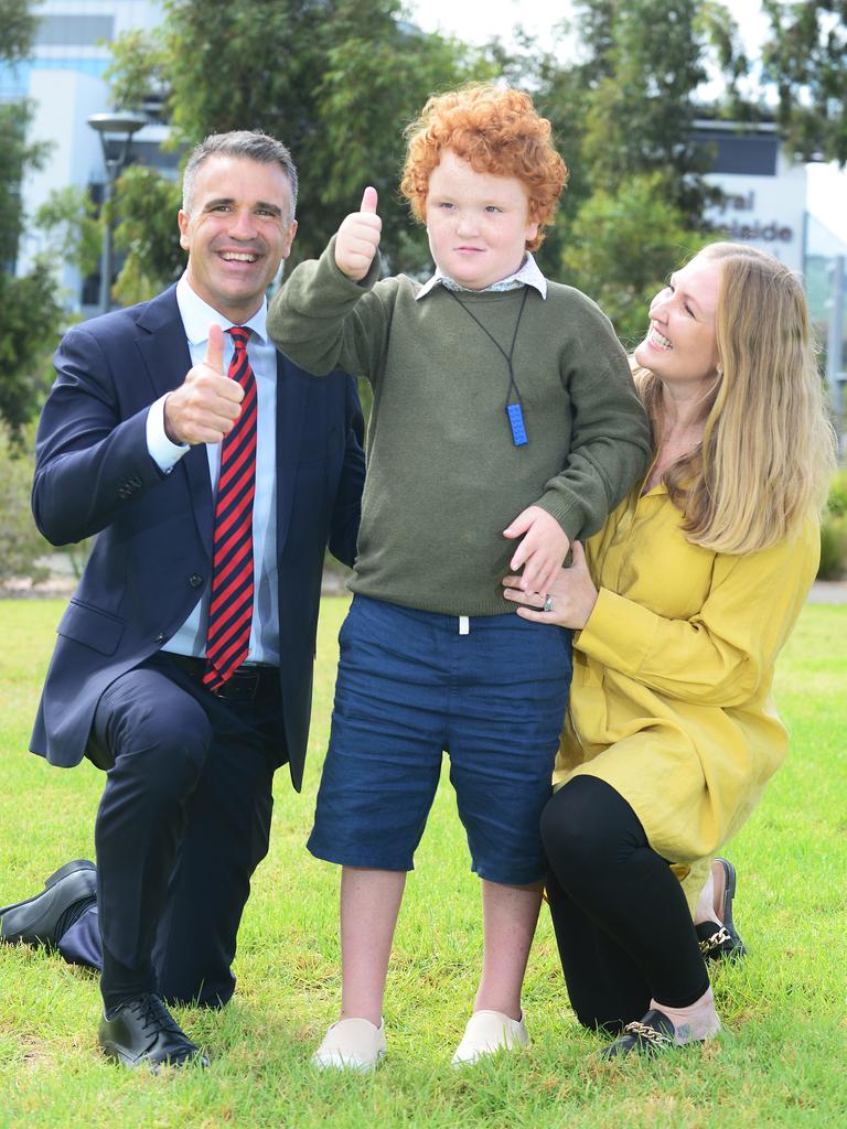 Sami Glastonbury with son Frank, 8, and Labor Leader Peter Malinauskas near the site of the new WCH on Port Road. Picture: Michael Marschall