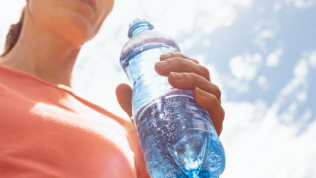 Woman holding water bottle. Picture: iStock