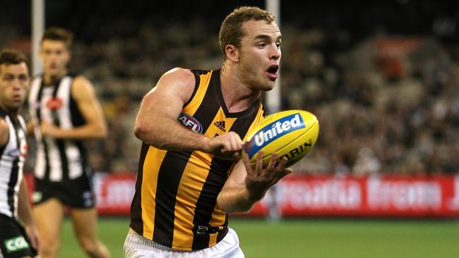 Tom Mitchell gets another handball away against the Pies. Picture: Wayne Ludbey