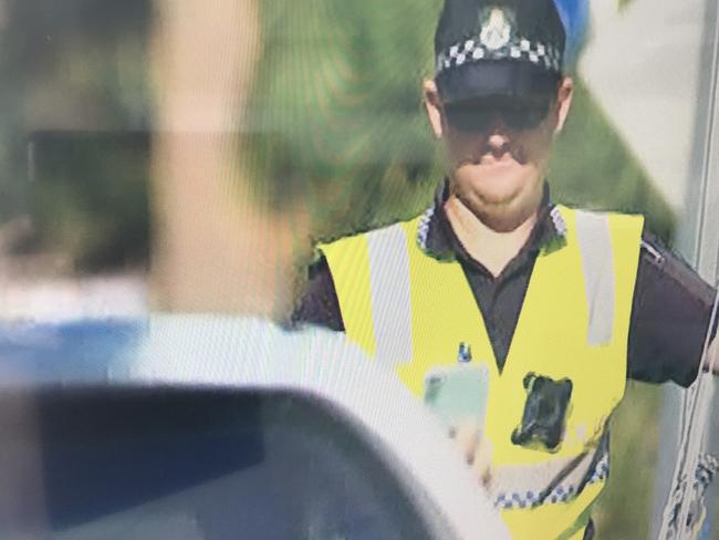 Screengrab of a driver passing through a checkpoint while holding his mobile phone which would normally attract a $1000 fine and the loss of four demerit points. Picture: Channel 7