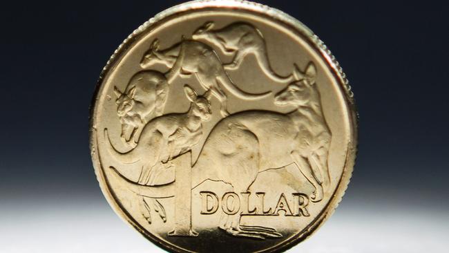 An Australian one-dollar coin is arranged for a photograph in Sydney, Australia, on Wednesday, April 17, 2013. Direct trading between the Australian dollar and yuan started on April 10. Photographer: Ian Waldie/Bloomberg