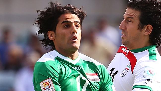 CANBERRA, AUSTRALIA - JANUARY 23: Alaa Abdulzehra of Iraq and Andranik Teymourian of Iran contest possession during the 2015 Asian Cup match between Iran and Iraq at Canberra Stadium on January 23, 2015 in Canberra, Australia. (Photo by Mark Nolan/Getty Images)
