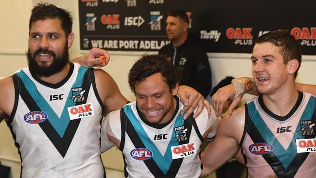 Port’s Paddy Ryder, Steven Motlop and Jack Trengove sing the song after the Power beat Carlton at the MCG last year. Picture: Quinn Rooney/Getty Images