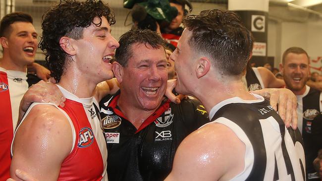 Brett Ratten sings the song with his players after the win. Picture: Michael Klein