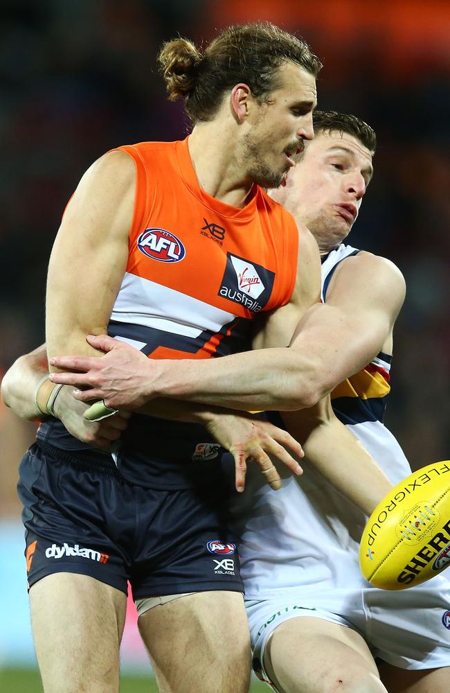 Phil Davis of the Giants is tackled by Adelaide’s Josh Jenkins on Saturday night. Picture: Mark Nolan/Getty Images