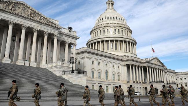 Members of the Virginia National Guard walk by the US Capitol in Washington on Sunday. Picture: AFP