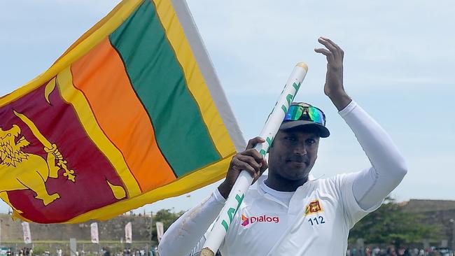 Sri Lanka's captain Angelo Mathews acknowledges the crowd as he celebrates their victory in the second Test match against Australia.