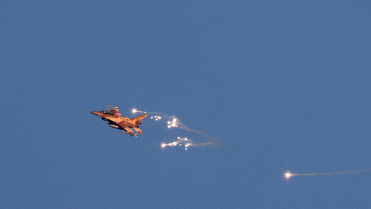 An Israeli Air Force fighter jet firing flares as it flies to intercept a hostile aircraft that launched from Lebanon over the border area. Picture: Jalaa Marey/AFP