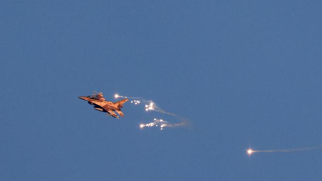 An Israeli Air Force fighter jet firing flares as it flies to intercept a hostile aircraft that launched from Lebanon over the border area. Picture: Jalaa Marey/AFP