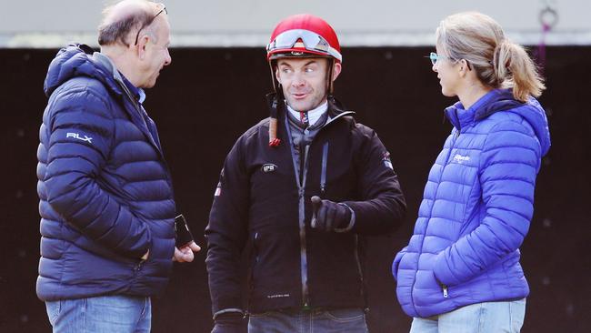 French jockey Olivier Peslier speaks with trainer Alain Couetil after riding Tiberian during a trackwork session at Werribee.