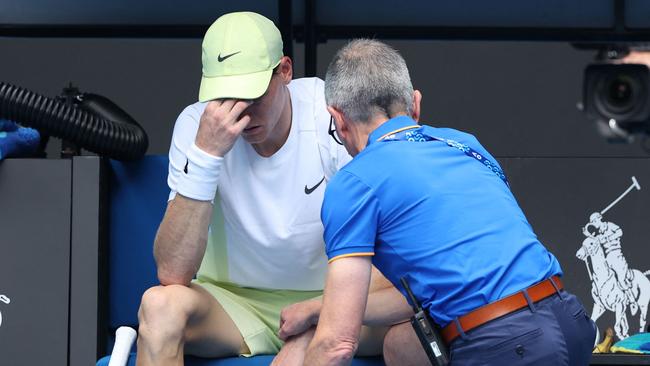 Italy's Jannik Sinner has a medical timeout whilst playing against Denmark's Holger Rune during their men's singles match on day nine of the Australian Open tennis tournament in Melbourne on January 20, 2025. (Photo by Martin KEEP / AFP) / -- IMAGE RESTRICTED TO EDITORIAL USE - STRICTLY NO COMMERCIAL USE --