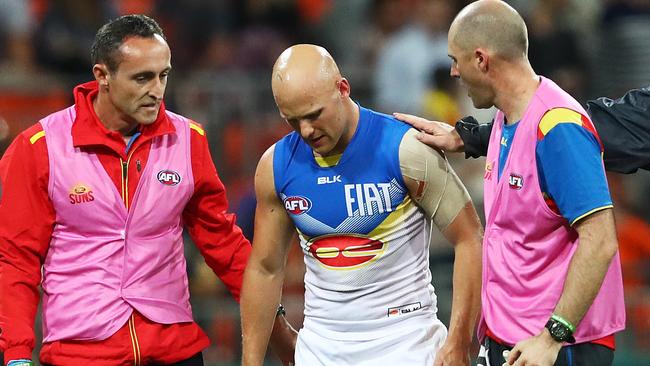 Gary Ablett is helped by trainers after a knock to the head against the Giants. Picture: Phil Hillyard