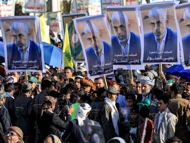 TOPSHOT - Supporters of Yemen's Huthis gather with pictures of Hamas' slain leader Yahya Sinwar during a rally held in the Huthi-controlled capital Sanaa on October 18, 2024 in protest against Israel's attacks on Lebanon and the ongoing war between Israel and Hamas militants in the Gaza Strip. Israel announced on October 17 the killing of Sinwar, mastermind of the October 7 attack, calling his death a "heavy blow" to the Palestinian group it has been fighting for more than a year. (Photo by Mohammed HUWAIS / AFP)