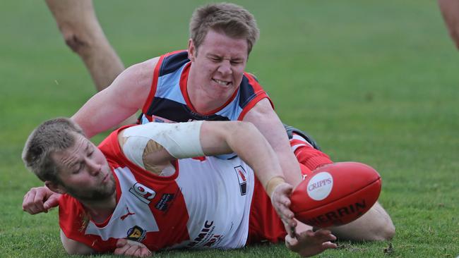 Lauderdale's Nick Connors tackles Clarence's Ryan Bailey in round one. Connors has been delisted by Lauderdale after recommencing work with Fremantle. Picture: LUKE BOWDEN