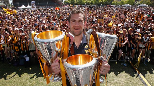 2015: Hawks captain Luke Hodge with the 2013, 2014 and 2015 premiership trophies at the Glenferrie Oval for a post-grand final family day. Picture: Quinn Rooney/Getty Images