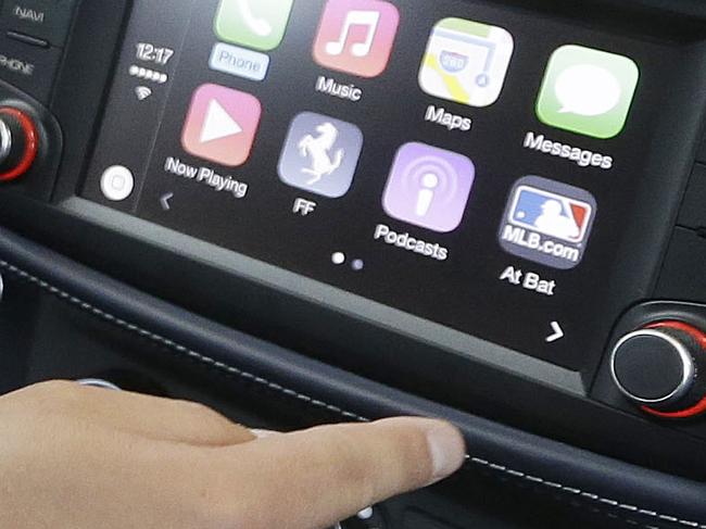 Stephen Chick with Apple gives a demonstration of CarPlay in a Ferrari at the Apple Worldwide Developers Conference in San Francisco, Monday, June 2, 2014. (AP Photo/Jeff Chiu)