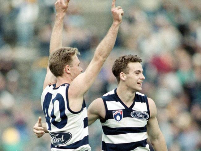 Geelong lesser lights Paul Brown and Aaron Lord celebrate the against-the-odds win.