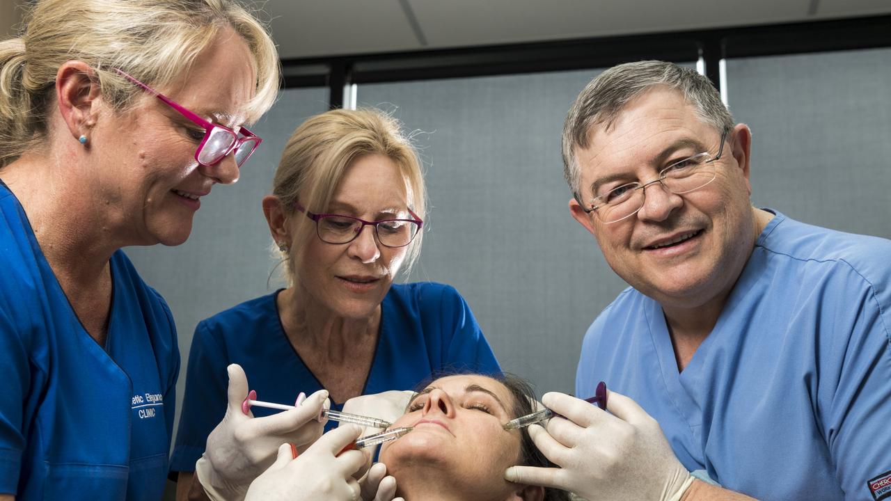 The team at Cosmetic Elegance (from left) nurse Liz Waugh, nurse Vicki Piets and Dr Eddie Roos have fun with staff member Jo Aspromourgos as they are named the best cosmetic injectors in The Chronicle's 2021 Best of Toowoomba series, Thursday, October 21, 2021. Picture: Kevin Farmer