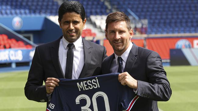 Lionel Messi receives his Paris Saint-Germain jersey from president Nasser Al Khelaifi