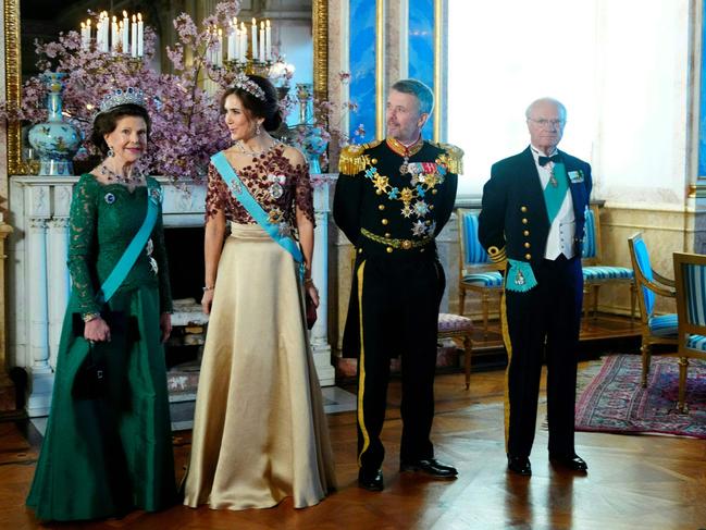 Queen Silvia of Sweden, Queen Mary of Denmark, King Frederik X of Denmark and King Carl XVI Gustaf of Sweden wait for the arrival of guests at a banquet at Stockholm Palace in Stockholm, Sweden. Picture: Ritzau Scanpix / AFP