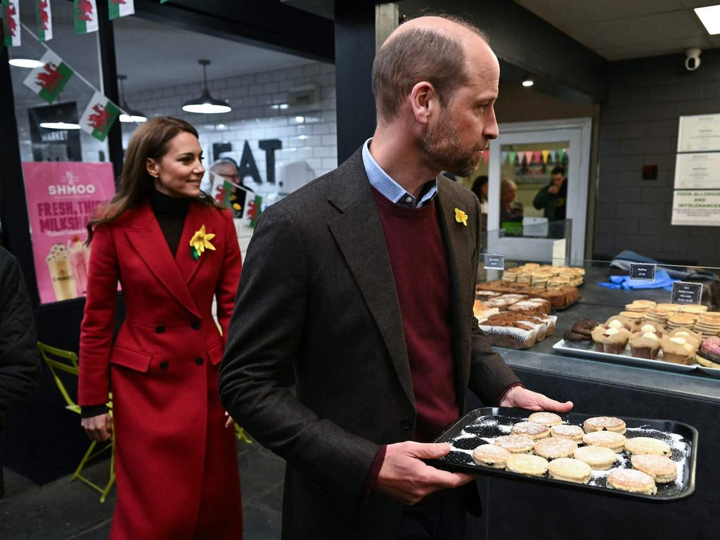 Prince William, Prince of Wales distributes to wellwishers the Welsh Cakes made by himself and Catherine, Princess of Wales, during a visit to Pontypridd Market. Picture: AFP