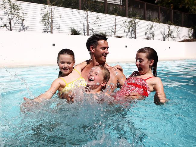 ***UNDER EMBARGO - NOT FOR USE BEFORE SATURDAY 28 NOVEMBER 2015***Pictured is Matt Leacy from Landart Landscapes with his kids Sienna 9, Amalija 7 and Thomas 5 swimming in Avalon today. Matt has found that around 80% of their clients are now opting for installation of magnesium filtration systems in pools because it provides a more therapeutic option. Picture: Tim Hunter.