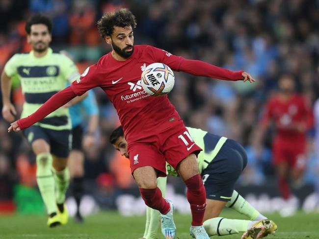 LIVERPOOL, ENGLAND - OCTOBER 16: Mohamed Salah of Liverpool gets away from Joao Cancelo of Manchester City to go on and score their side's first goal during the Premier League match between Liverpool FC and Manchester City at Anfield on October 16, 2022 in Liverpool, England. (Photo by Laurence Griffiths/Getty Images)