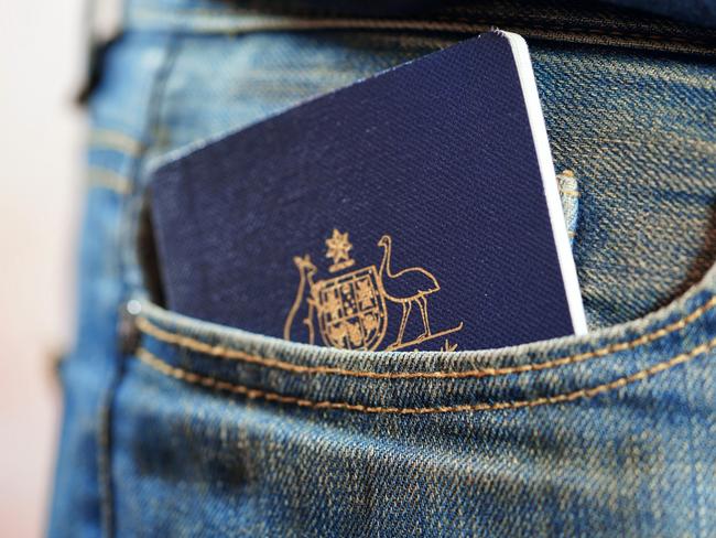 ESCAPE: Australian passport in mans jeans pocket, close up. Picture: Istock