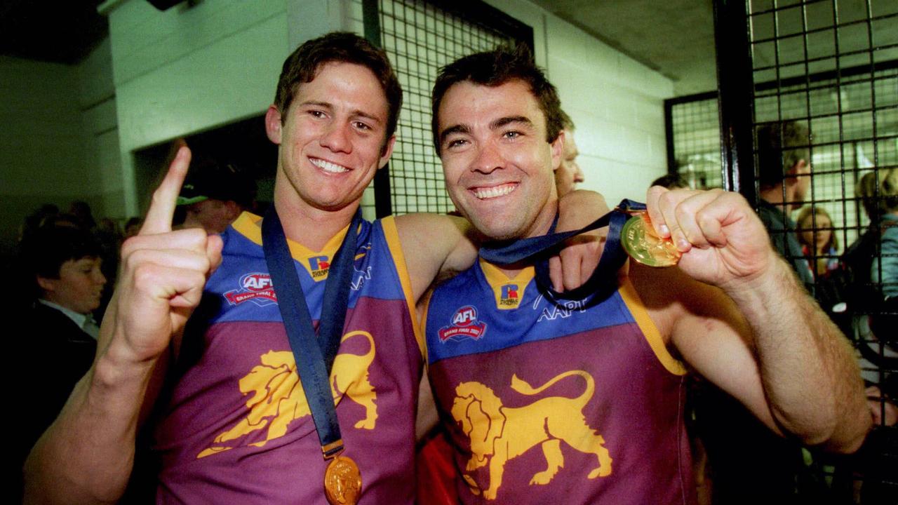 Aaron Shattock (left) and Chris Scott after the 2002 grand final victory.