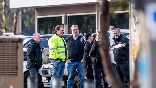 John Setka (yellow jacket) meets with other union leaders before entering the meeting. Picture: Jake Nowakowski