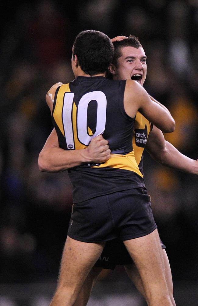 Dustin Martin celebrates with Shane Edwards after kicking a last quarter goal at then-Etihad Stadium in 2010.