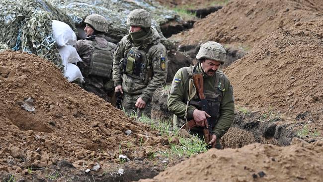 Ukrainian servicemen stand in a trench near their position near the town of Bakhmut. Picture: AFP