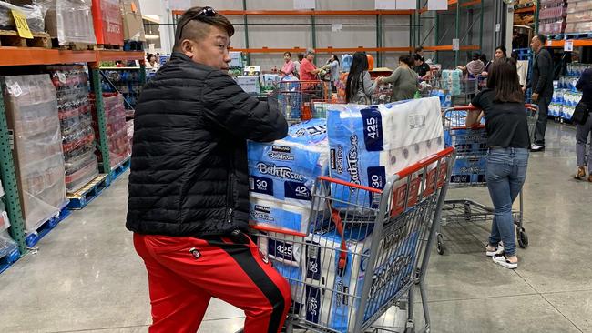 A man prepares to buy 150 rolls of toilet paper at a Los Angeles store. Picture: AFP