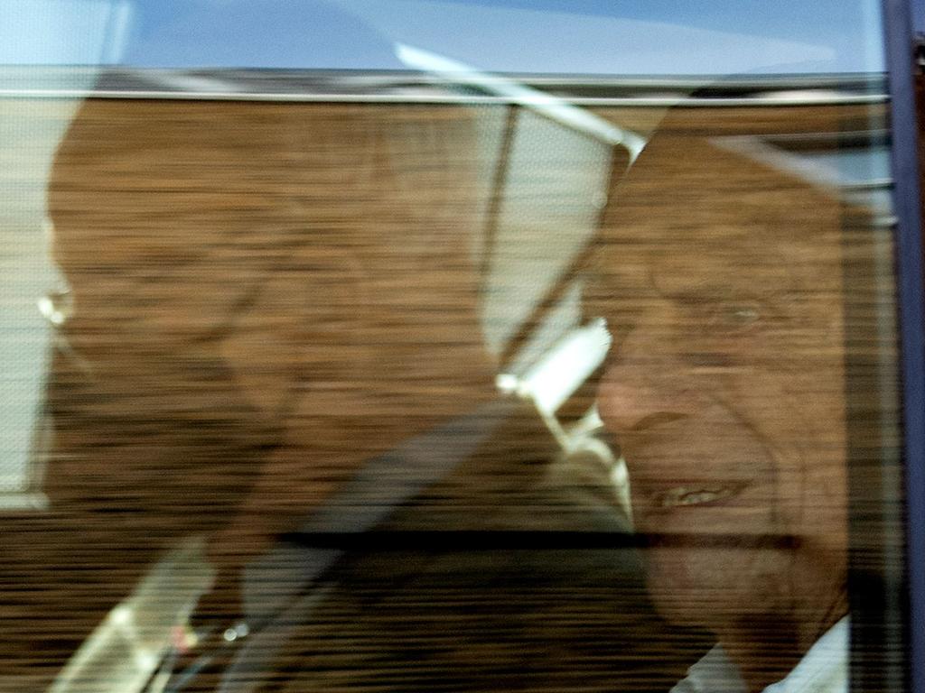 The 99-year-old gave a slight smile as he was driven away. Picture: Justin Tallis / AFP