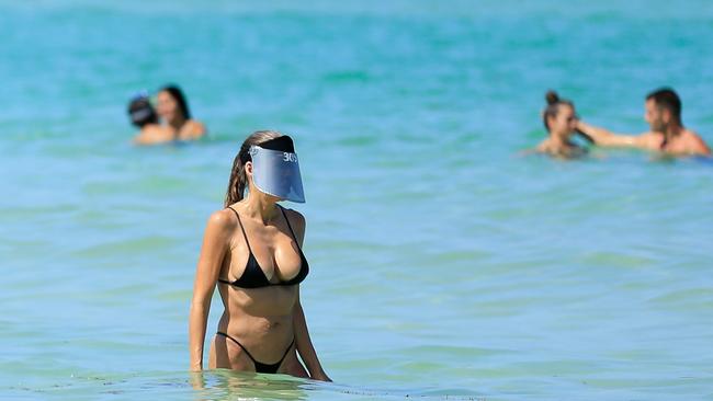 Getting back to (semi) normality.... : A woman wears a face shield at Miami Beach, Florida.