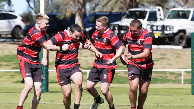 St Edward's College players Beau Newlands, left, Daniel Peters, Tyler Moriarty and Makenzie Zammit celebrate their cliff-hanger win over Farrer. Picture by Peter Lorimer.