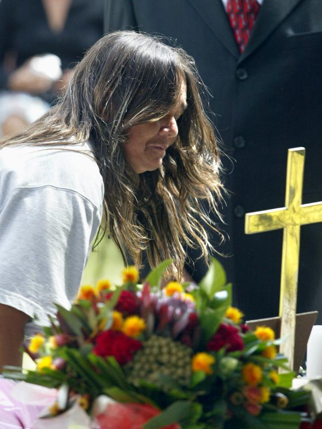 Gail Hickey lays a wreath at the funeral service of her son Thomas (TJ) Hickey.