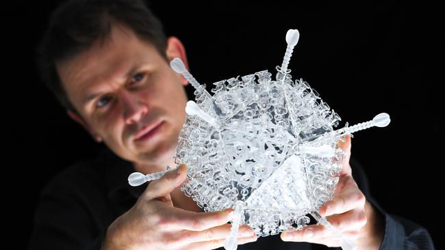 Artist Luke Jerram with his glass sculpture of the Oxford-AstraZeneca coronavirus vaccine in Bristol, England. Picture: Getty Images