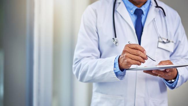 Shot of an unrecognisable male doctor writing on a digital tablet while standing inside of a hospital during the day. picture: iStock