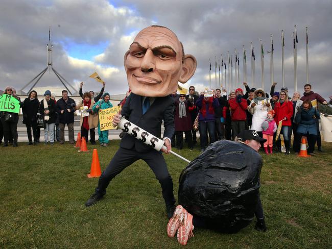 An environmental supergroup protesting against polluting coal and clean energy on the lawns of Parliament House in Canberra. Two protestors wearing large heads of the Prime Minister Malcolm Turnbull and former Prime Minister Tony Abbott on the lawns of Parliament House in Canberra. Picture: Gary Ramage