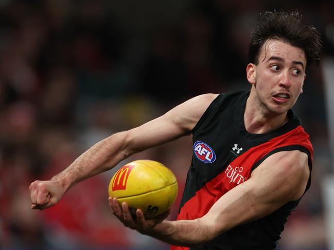 MELBOURNE, AUSTRALIA - AUGUST 16: Nic Martin of the Bombers handballs during the round 23 AFL match between Essendon Bombers and Sydney Swans at Marvel Stadium, on August 16, 2024, in Melbourne, Australia. (Photo by Daniel Pockett/Getty Images)