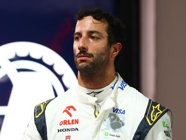 SINGAPORE, SINGAPORE - SEPTEMBER 21: 16th placed qualifier Daniel Ricciardo of Australia and Visa Cash App RB walks in the Pitlane during qualifying ahead of the F1 Grand Prix of Singapore at Marina Bay Street Circuit on September 21, 2024 in Singapore, Singapore. (Photo by Mark Thompson/Getty Images)