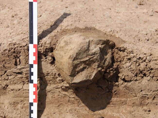 This undated photo made available in May 2015 by the Mission Prehistorique au Kenya - West Turkana Archaeological Project shows the excavation of a stone tool found in the West Turkana area of Kenya. This and other artifacts, dated at 3.3 million years old, are much older than the earliest known trace of our own branch of the evolutionary family tree. So it’s a new challenge to the traditional idea that only members of our branch made stone tools. The discovery was reported in the journal Nature on Wednesday, May 20, 2015. (MPK-WTAP via AP)