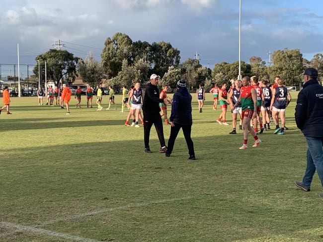 Pines coach Paddy Swayn shakes hands with Edi-Asp coach Ben Walker.