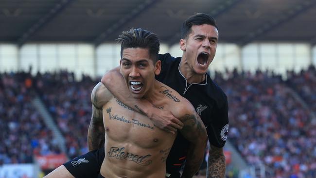 Liverpool's Brazilian midfielder Roberto Firmino (L) celebrates scoring his team's second goal with Philippe Coutinho.