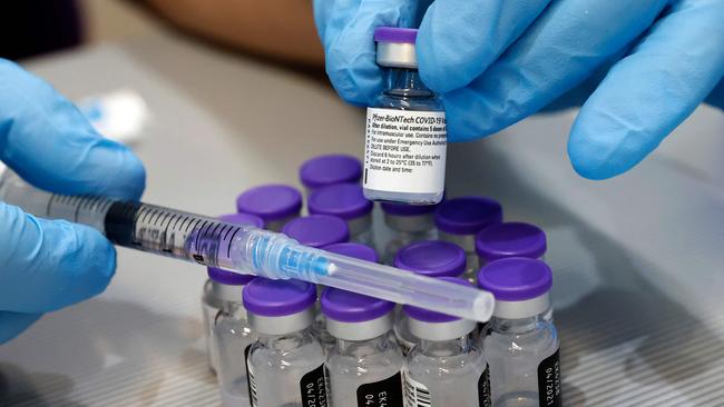 Some Aussies workplaces have mandated vaccines. Picture: Jack Guez / AFP