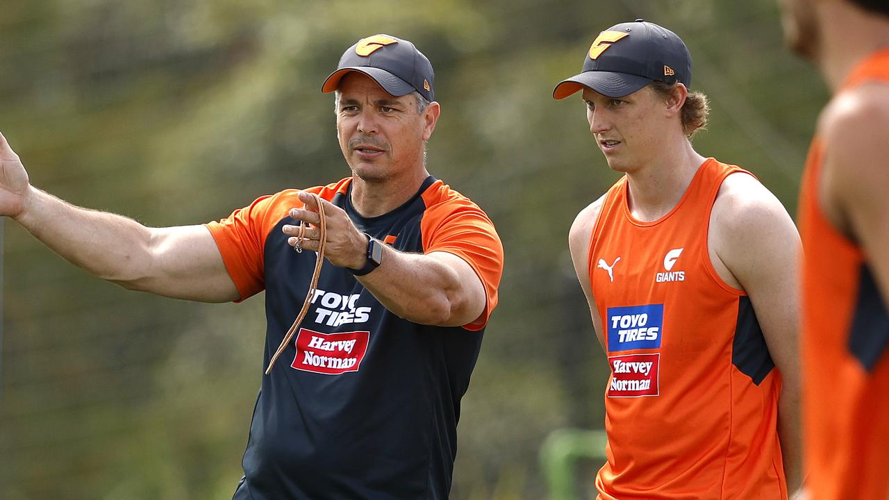 Lachie Whitfield gets instructions from new coach Adam Kingsley.