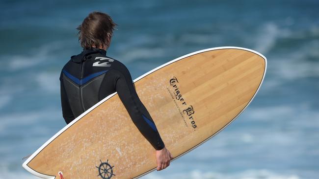 A surfer in a Billabong wetsuit looks out towards the waves at Bells Beach in Torquay. Picture: Carla Gottgens/Bloomberg