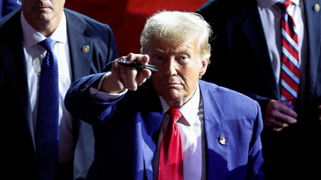 TOPSHOT - Former US President and Republican presidential candidate Donald Trump points to the crowd as he leaves after speaking during a town hall meeting in La Crosse, Wisconsin, on August 29, 2024. (Photo by KAMIL KRZACZYNSKI / AFP)