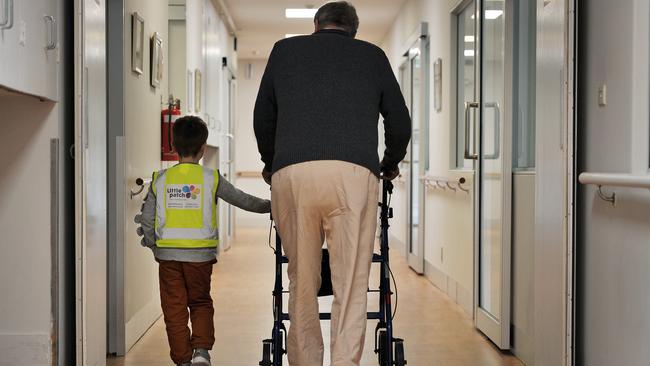 Ian talks a stroll with the help of little mate Andrew. Picture: Nicki Connolly